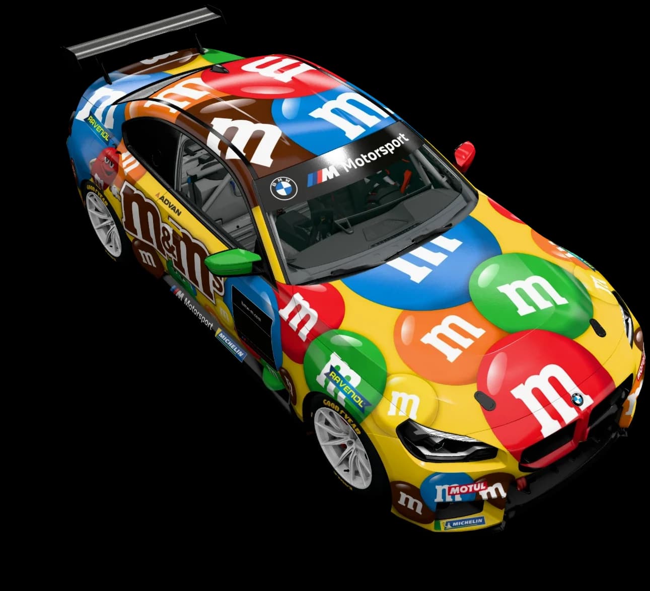 BMW M2 Racing in a yellow livery covered in red, green, blue, orange and brown M&M’s, seen from above at three-quarters